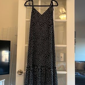 Black polka dot spaghetti strap ruffle bottom midi.